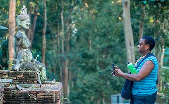 Tourist taking pictures at the ruins, Chiang Mai, Thailand. Grasshopper Day Tours