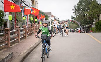Biking on a bridge, Hoi An, Vietnam. Grasshopper Day Tours