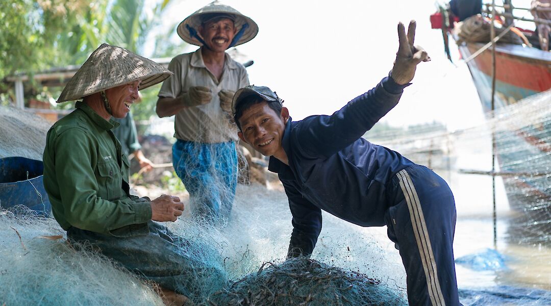 Local Fishermen fixing their nets, Hoi An, Vietnam. Grasshopper Day Tours
