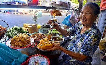 Local preparing a sandwich, Hoi An, Vietnam. Grasshopper Day Tours