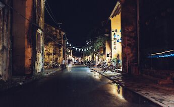 Bikes, pedestrians, and lanterns on the evening streets of Hoi An, Vietnam. Rafael Fabricio@Unsplash