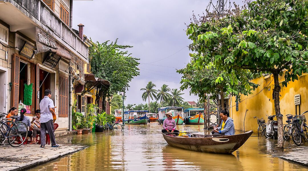 Boats and bikes on the streets, Rainy season in Hoi An, Vietnam. Toomas Tartes@Unsplash