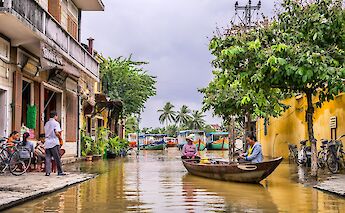 Boats and bikes on the streets, Rainy season in Hoi An, Vietnam. Toomas Tartes@Unsplash