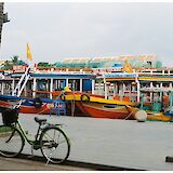 Colorful tourist boats and a bike in Hoi An, Vietnam. Le Porcs@Unsplash