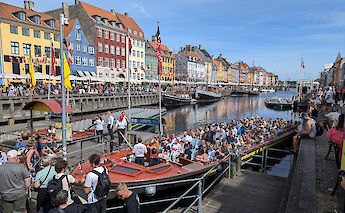 Tourists at Nyhavn, Copenhagen, Denmark. CC:Dicklyon