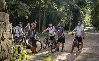 Listening to the guide's lecture while on a stop, Siem Reap, Cambodia. Grasshopper Day Tours