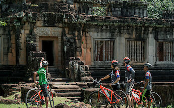 A lecture from the guide while near Bayon, Siem Reap, Cambodia. Grasshopper Day Tours