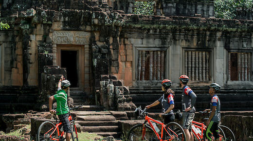 A lecture from the guide while near Bayon, Siem Reap, Cambodia. Grasshopper Day Tours