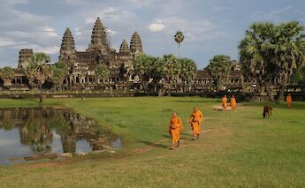 Monks walking through the grounds of Angkor Wat, Siem Reap, Cambodia. Dick Hoskins@Unsplash