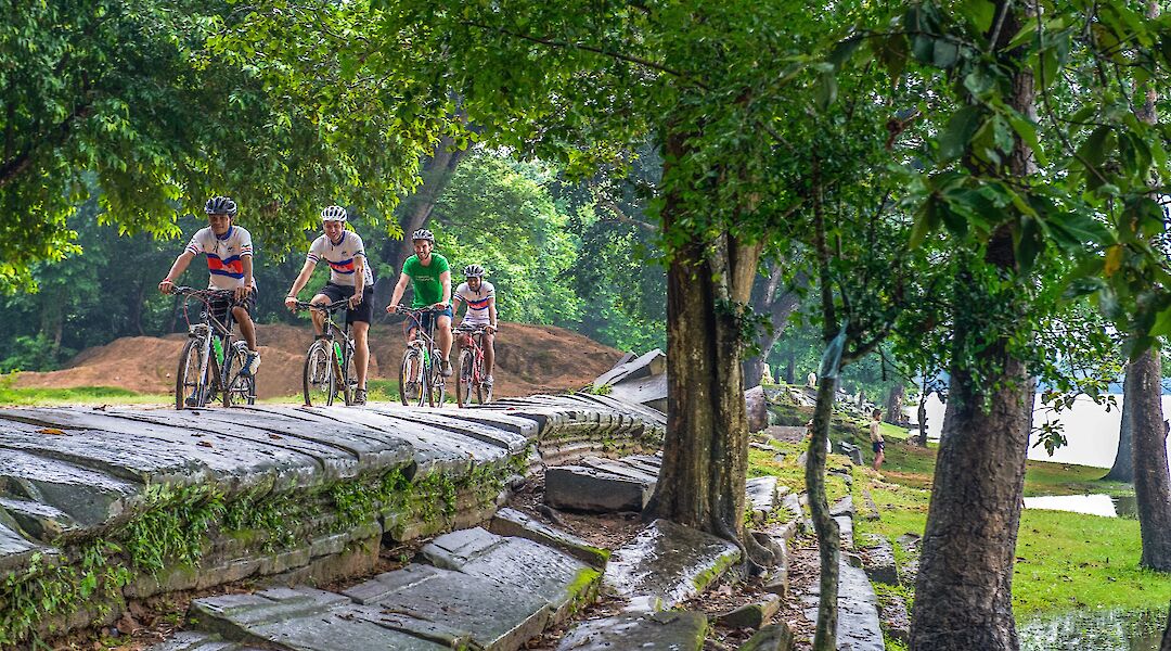 Biking up stone paths at Angkor Temples, Siem Reap, Cambodia. Grasshopper Day Tours