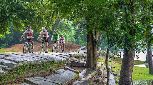 Biking up stone paths at Angkor Temples, Siem Reap, Cambodia. Grasshopper Day Tours