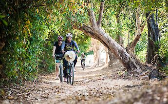 Early morning biking to Angkor Temples, Siem Reap, Cambodia. Grasshopper Day Tours
