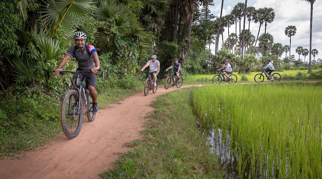 E-biking through the dirt trails of the countryside of Siem Reap, Cambodia. Grasshopper Day Tours