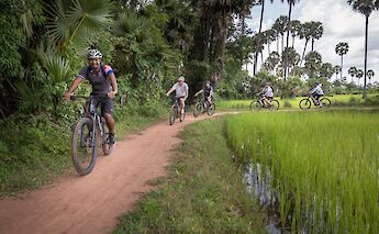 E-biking through the dirt trails of the countryside of Siem Reap, Cambodia. Grasshopper Day Tours