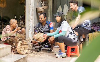 Learning basket weaving from a local in Siem Reap, Cambodia. Grasshopper Day Tours