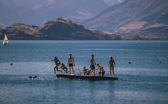 People swimming at Lake Wanaka. Taylor Brandon@Unsplash