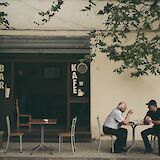 Older gentlemen dining al fresco, Durres, Albania. Juri Gianfrancescojpg@Unsplash