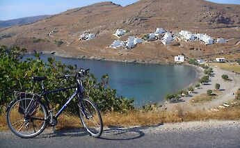 Cycling from Merichas toward Chora, with sweeping coastal views. -toIH