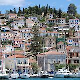 Poros Town and the harbor crowned by its iconic hillside clock tower. -toIH