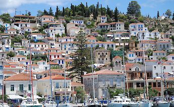 Poros Town and the harbor crowned by its iconic hillside clock tower. -toIH