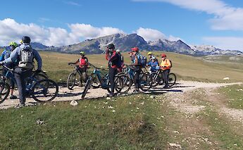 Stopping for briefing with mountains in the background, Sinjajevina, Zabljak, Montenegro. Durmitor Adventure Tours
