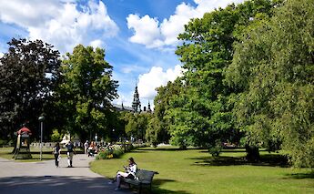 Reading on a bench at Djurgarden, Stockholm, Sweden. Flickr: Dan