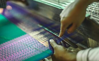 Traditional art of weaving being taught on Silk Island, Phnom Penh, Cambodia. Grasshopper Active Day Tours