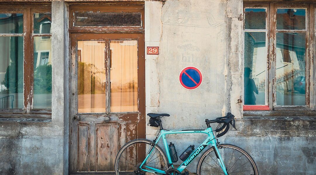 Bike parked against a wall in Beaune, France. Unsplash:Joran Maaswinkel
