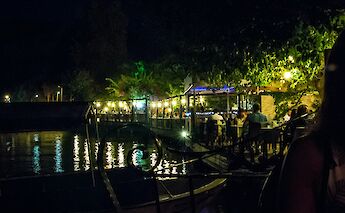 Illuminated restaurant by the water, Dalyan, Turkey. Unsplash:Ray Harrington