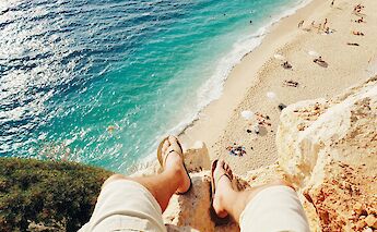 Sitting on top of a cliff, Fethiye, Turkey. Unsplash:Ahmet Sali