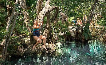 Leaping into a cenote, Tulum, Mexico. CC:Mexico Kan Tours