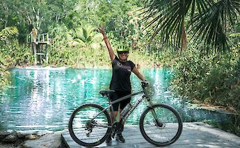 Posing with a bike at a cenote, Tulum, Mexico. CC:Mexico Kan Tours