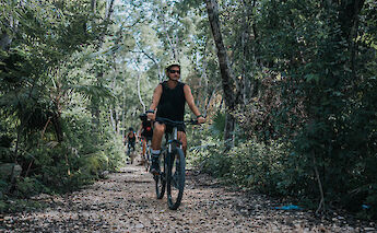 Riding a bike on a jungle path, Tulum, Mexico. CC:Mexico Kan Tours