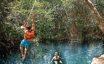 Using a rope to jump into a cenote, Tulum, Mexico. CC:Mexico Kan Tours
