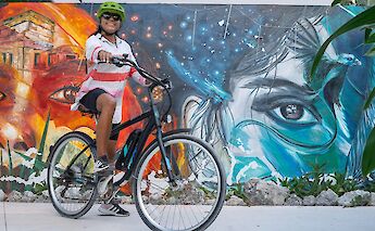 Posing next to a mural, Tulum, Mexico. CC:Mexico Kan Tours
