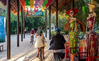 Riding past traditional art, Tulum, Mexico. CC:Mexico Kan Tours