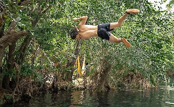 Swinging off the vines at a cenote, Tulum, Mexico. CC:Mexico Kan Tours