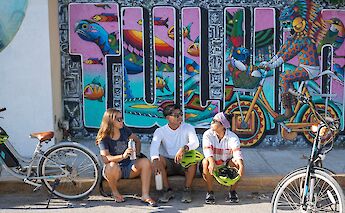 Taking a break by a mural, Tulum, Mexico. CC:Mexico Kan Tours