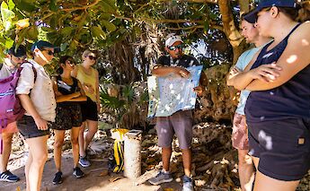 Tour guide explaining a map, Tulum, Mexico. CC:Mexico Kan Tours