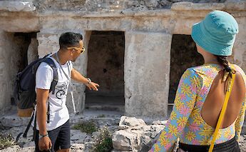 Tour guide pointing at the ruins, Tulum, Mexico. CC:Mexico Kan Tours