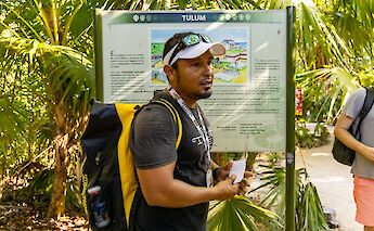 Tour guide talking to a group, Tulum, Mexico. CC:Mexico Kan Tours