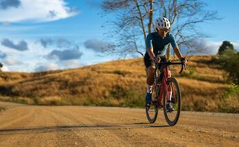 Gravel biking under blue skies. Getty Images@Unsplash