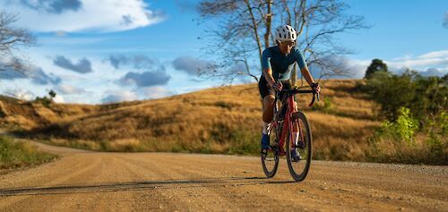 Gravel biking under blue skies. Getty Images@Unsplash