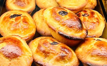 A close-up of traditional pasticciotti pastries with golden-brown crusts.