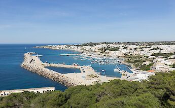 The harbor at Santa Maria di Leuca, the tip of Salento, with docks and buildings along the coastline.