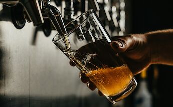 Pouring a craft beer. Unsplash:Josh Olalde