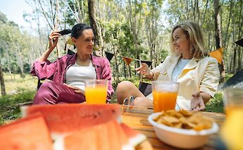 Enjoying food and conversation outdoors. George Dagerotip@Unsplash