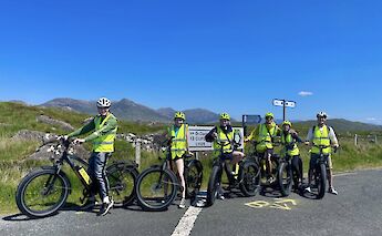 Tour group at a road sign, Galway, Ireland. CC:Fat Bike Galway