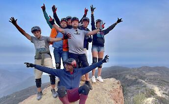 Arms in the air on top of a rock, Malibu, California, USA. CC:LifeRush Adventures