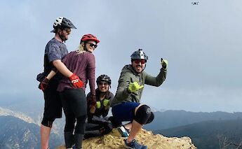 Group posing on top of a rock, Malibu, California, USA. CC:LifeRush Adventures